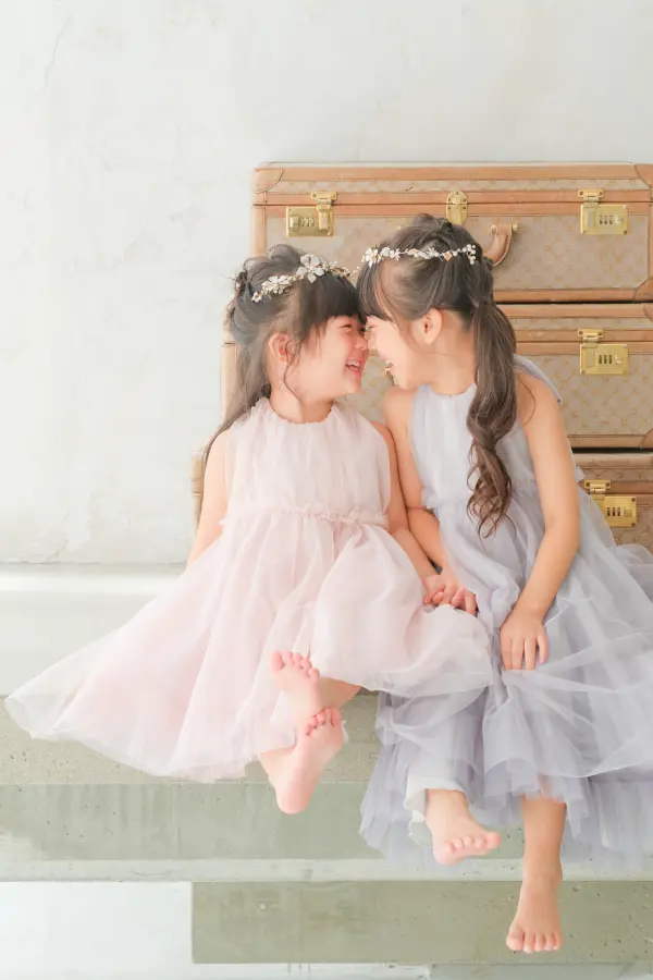 ドレスを着用した女の子二人の家族写真